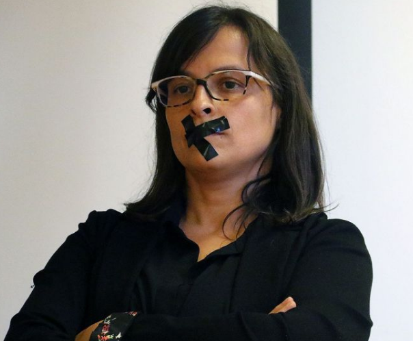 Vanessa Mendoza Cortés is the president of the women’s rights organization, Stop Violence. In this image, she has black tape across her lips.