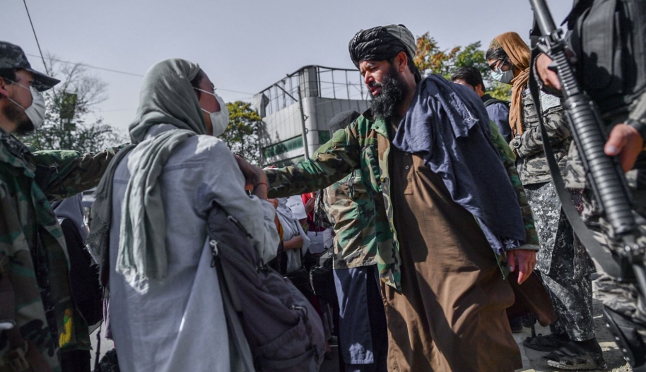 Taliban members stop women protesting for women's rights in Kabul on October 21, 2021. Photo by BULENT KILIC/AFP via Getty Images.