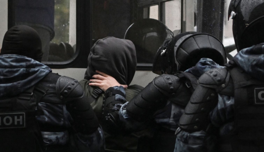 Police officers detain a man in Moscow on September 24, 2022, following calls to protest against the partial mobilisation announced by the Russian President. Photo by AFP via Getty Images.