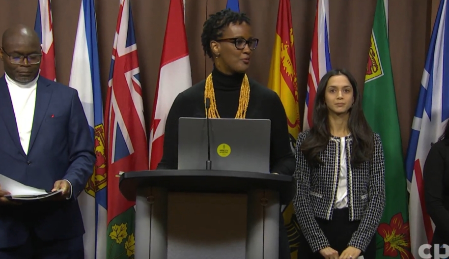 Amnesty International Canada secretary general Ketty Nivyabandi speaks at podium during press conference in Ottawa