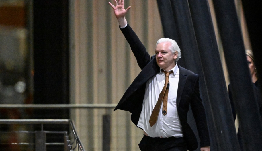 WikiLeaks founder Julian Assange waves after arriving at Canberra Airport in Canberra on June 26, 2024. Photo by WILLIAM WEST / AFP) (Photo by WILLIAM WEST/AFP via Getty Images.