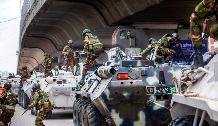 Bangladeshi soldiers disembark armored vehicles as they patrol the streets to disperse the anti-quota protesters in Dhaka on July 20, 2024. Photo by -/AFP via Getty Images.